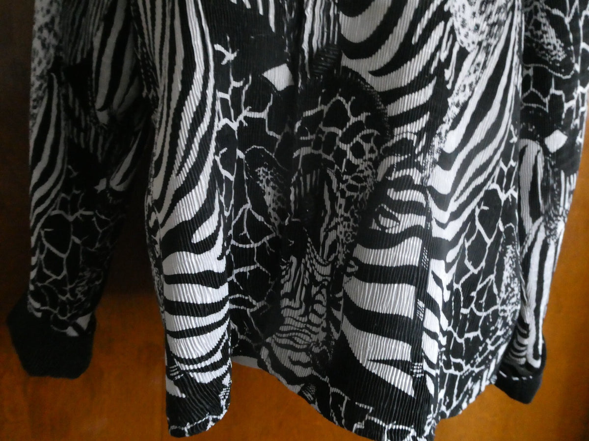 From Macys women's reversable black/white soft polyester blazer size 14 US