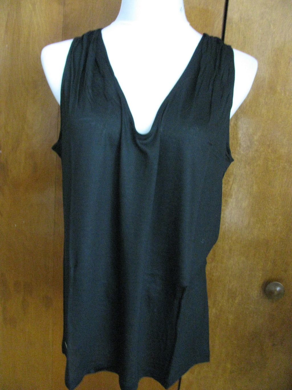 Lacoste women's black top runs big New