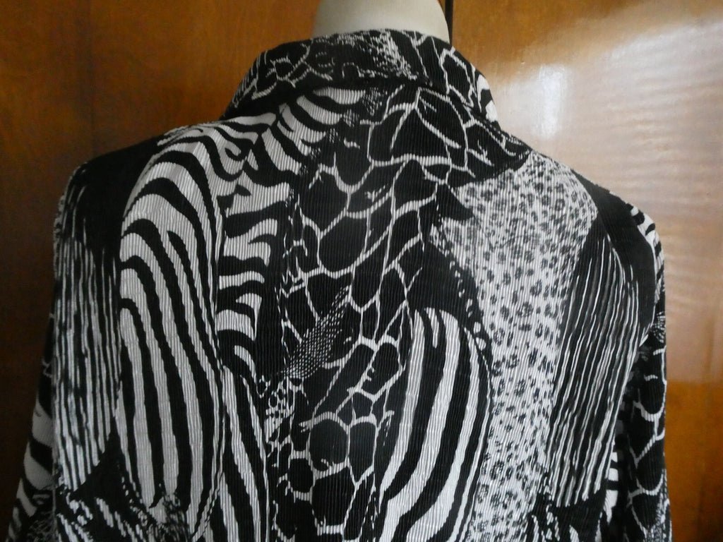 From Macys women's reversable black/white soft polyester blazer size 14 US
