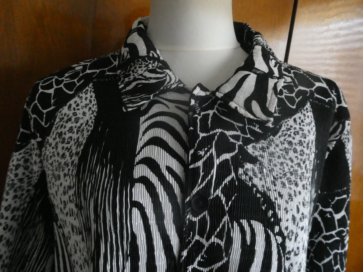 From Macys women's reversable black/white soft polyester blazer size 14 US