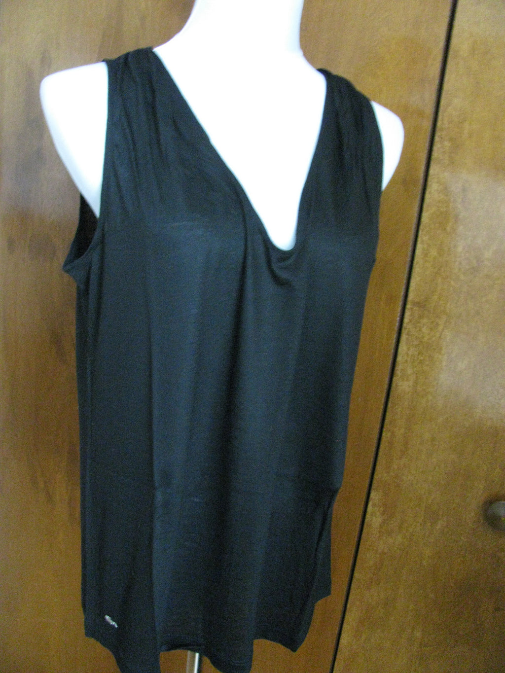 Lacoste women's black top runs big New