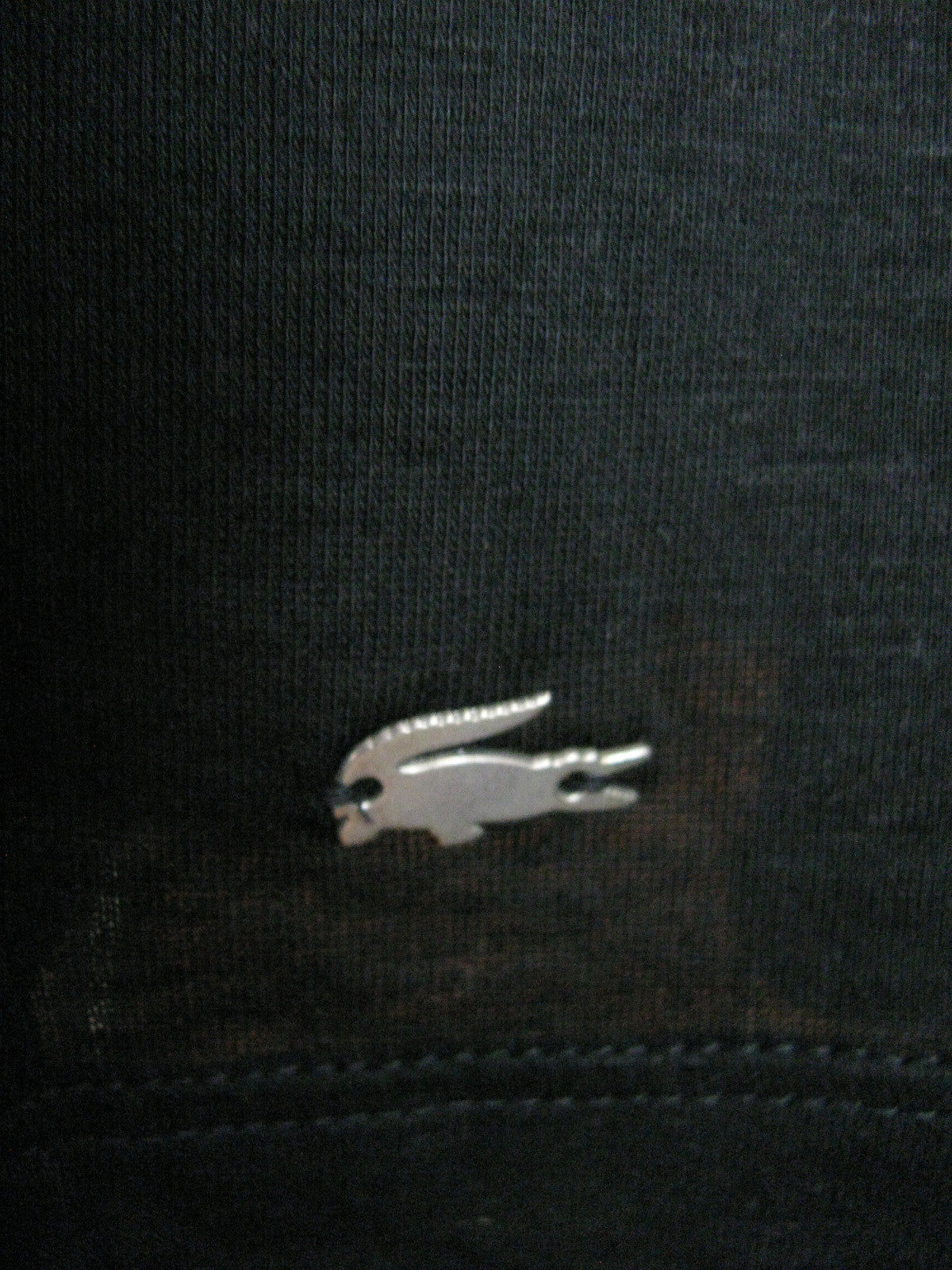 Lacoste women's black top runs big New