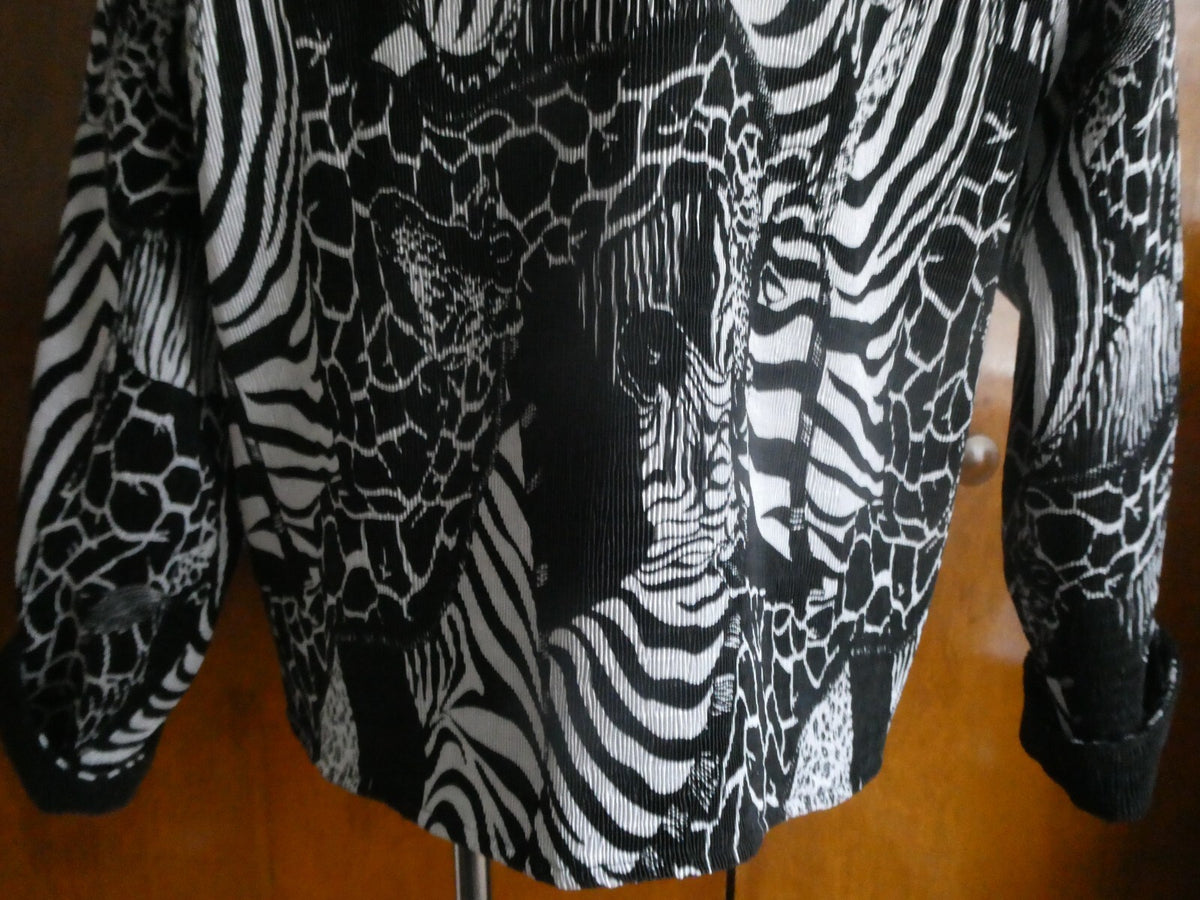 From Macys women's reversable black/white soft polyester blazer size 14 US