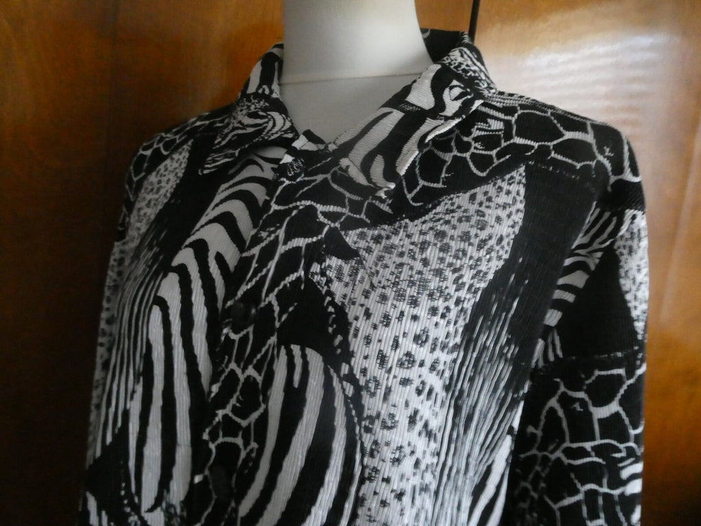 From Macys women's reversable black/white soft polyester blazer size 14 US